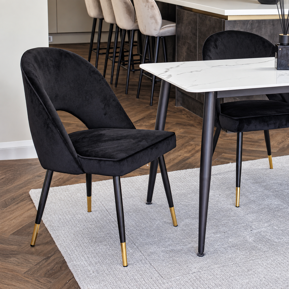 Astra velvet dining chair with black legs and gold tips